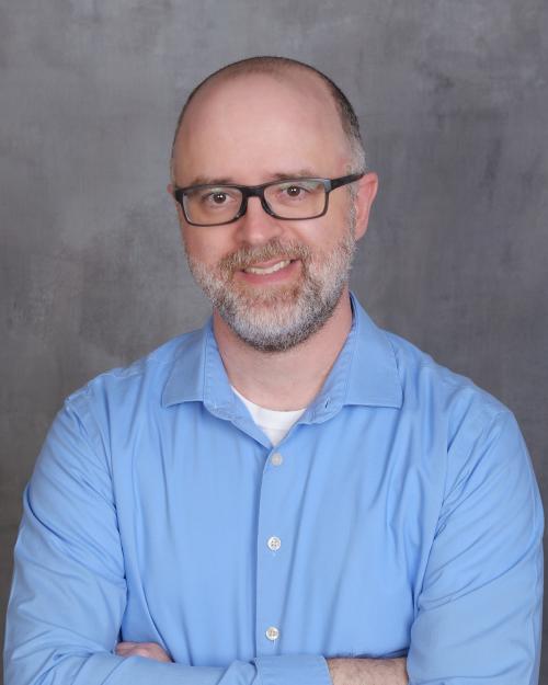 Joshua Tallent, man wearing blue shirt and glasses